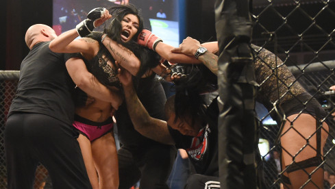 LAS VEGAS, NV - AUGUST 08:  Fighter Shelly "Aphrodite" DaSilva (2nd L) is restrained by coach Michael Modest (L) and assis...