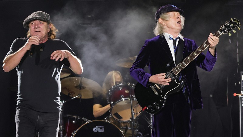 INDIO, CALIFORNIA - OCTOBER 07: (EDITORIAL USE ONLY) (L-R) Brian Johnson, Matt Laug, and Angus Young of AC/DC perform onstage