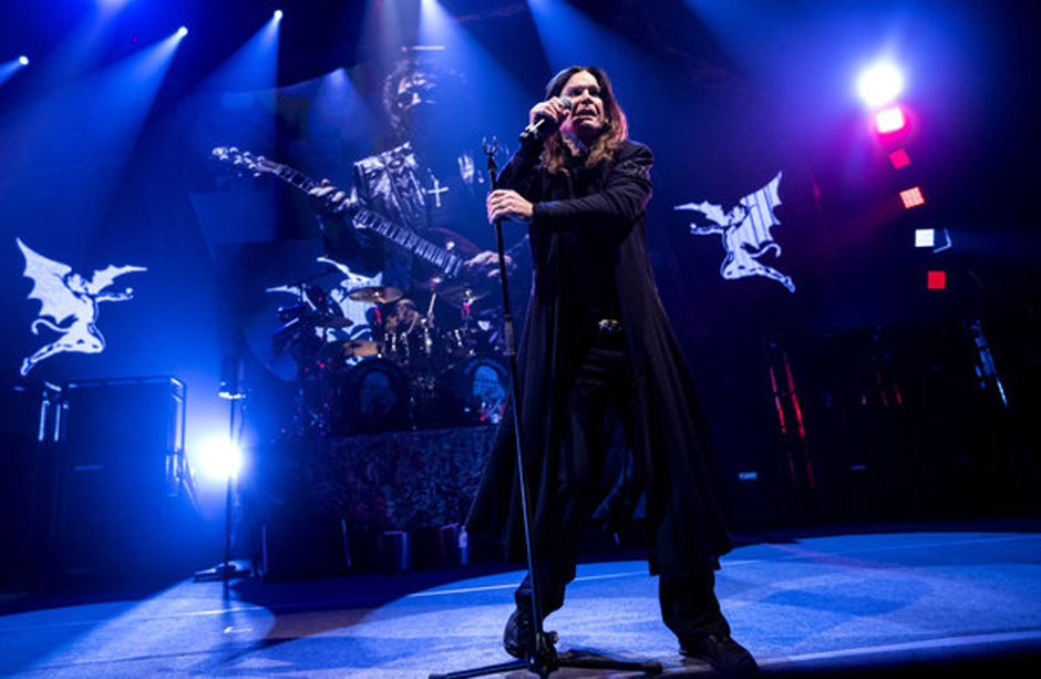 Singer Ozzy Osbourne of British rock band Black Sabbath, performs with guitarist Tony Iommi, seen on screen behind, during a 
