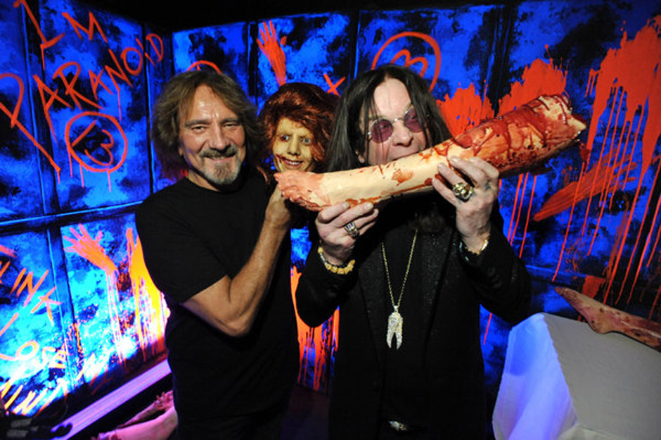 In this Tuesday, Sept. 17, 2013 photo, Geezer Butler, left, and Ozzy Osbourne pose with props at the 'Black Sabbath: 13 3D' m
