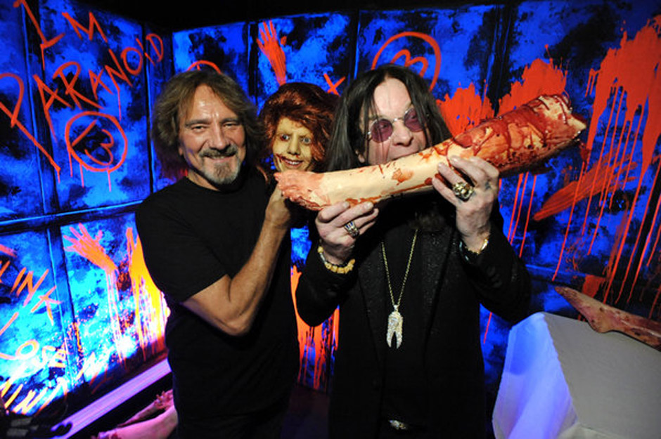 In this Tuesday, Sept. 17, 2013 photo, Geezer Butler, left, and Ozzy Osbourne pose with props at the 'Black Sabbath: 13 3D...