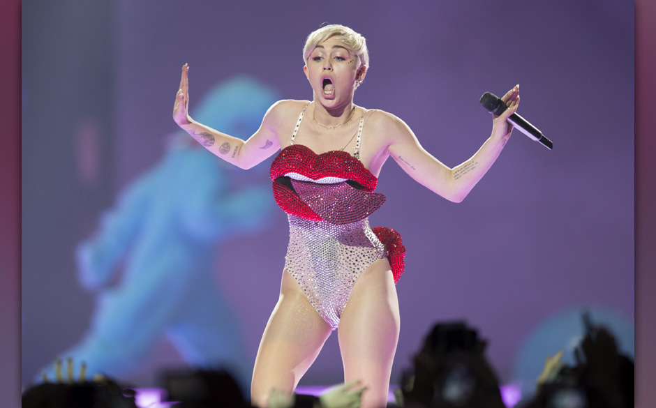 In this picture made available on Tuesday, May 27, 2014 US singer Miley Cyrus performs during a concert in Cologne, Germany, 