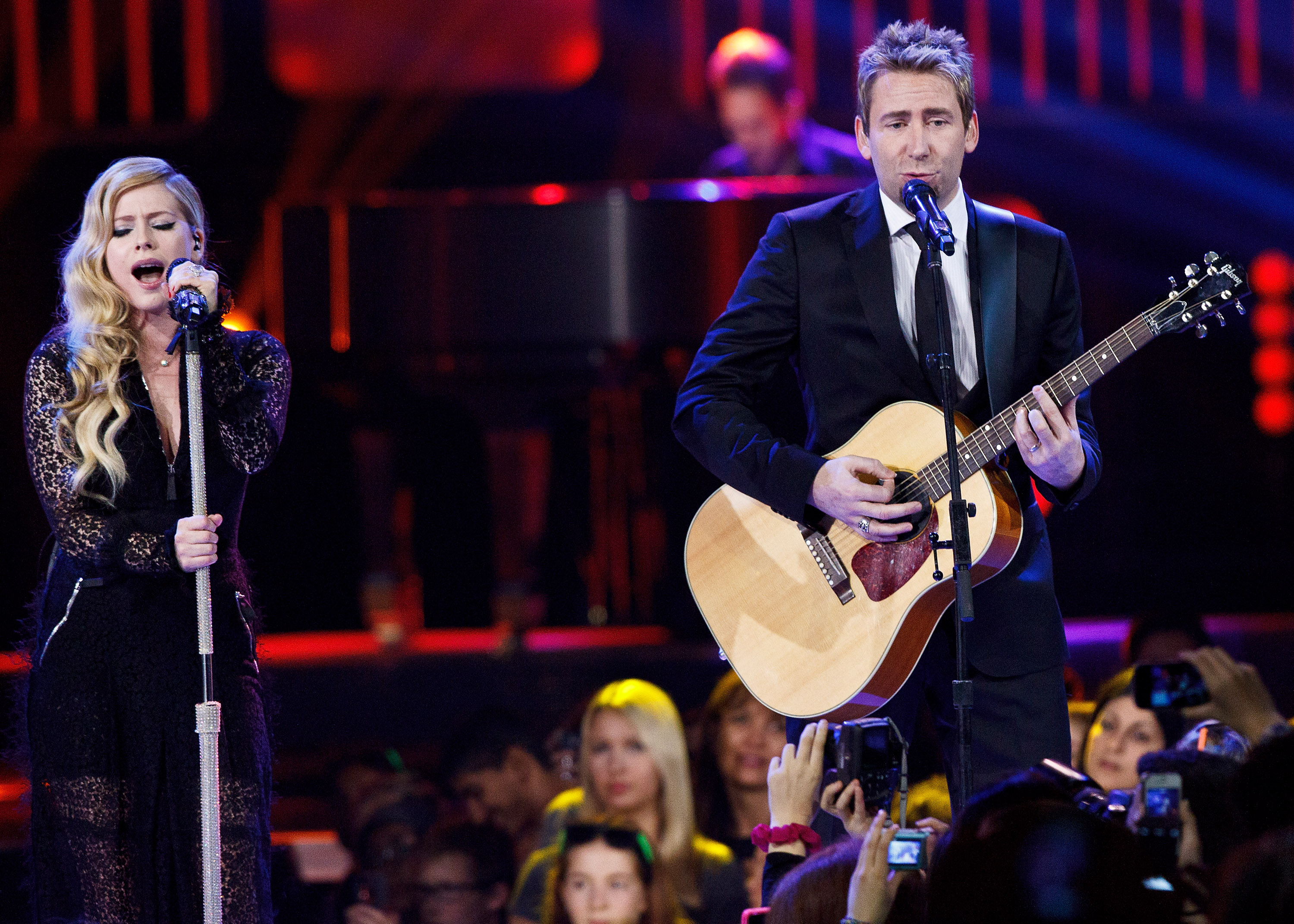 VANCOUVER, BC - OCTOBER 18:  Avril Lavigne (L) and Chad Kroeger performing on We Day at Rogers Arena on October 18, 2013 i...