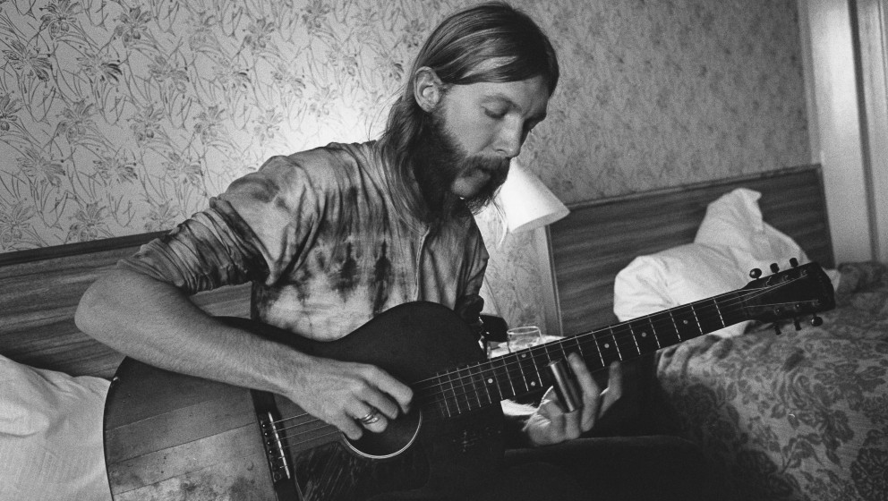 SPARTANBURG, SC - OCTOBER 17: Guitarist Duane Allman uses a steel slide on an acoustic guitar in his hotel room before the...