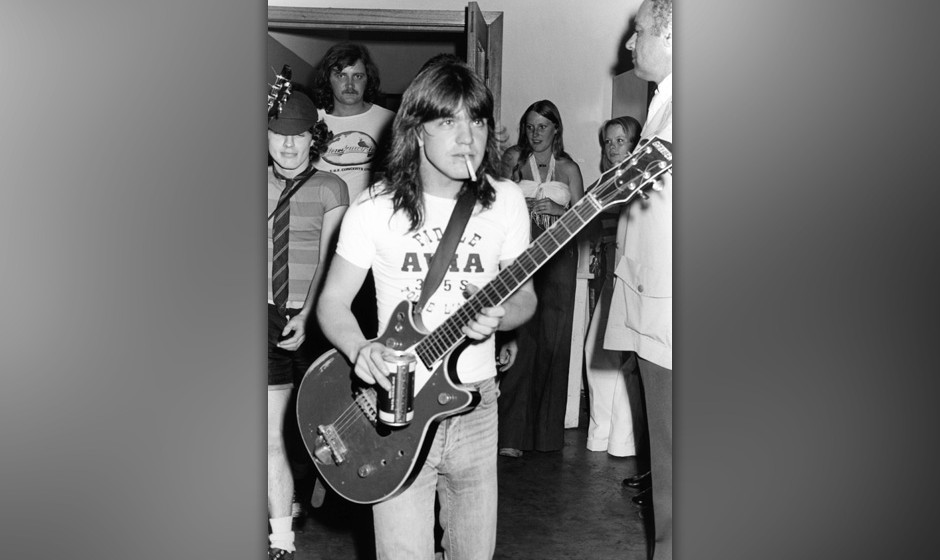 AUSTRALIA - JANUARY 01:  Photo of AC/DC and Malcolm YOUNG and Angus YOUNG; Malcolm Young and Angus Young (behind) backstag...