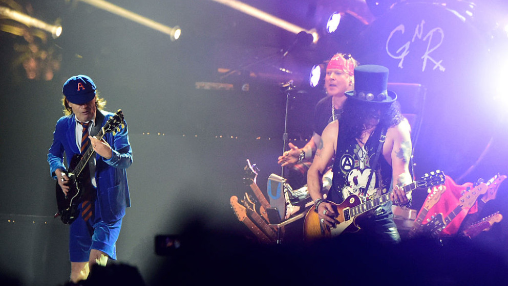 INDIO, CA - APRIL 16:  (L-R) Musician Angus Young of AC/DC performs onstage with Axl Rose and Slash of Guns N' Roses during d