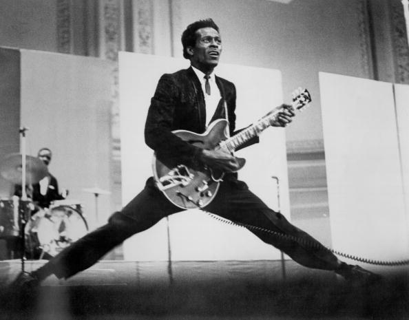 CIRCA 1968:  Rock and roll musician Chuck Berry does the splits as he plays his Gibson hollowbody electric guitar in circa 19