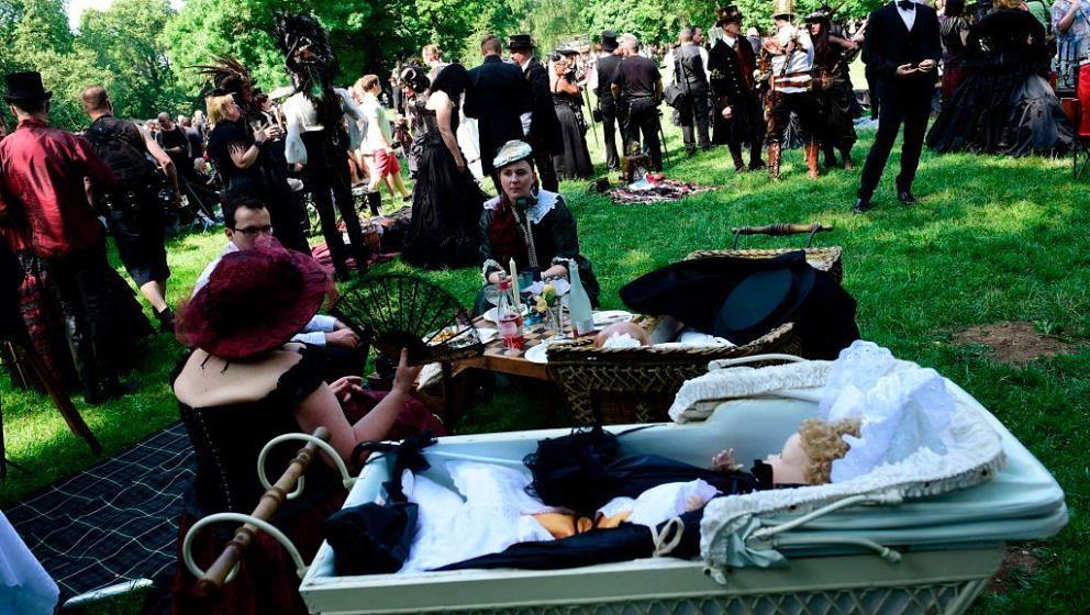 Dressed up people attend a so-called 'Victorian Picnic' during the Wave-Gotik-Treffen (WGT) festival in Leipzig, eastern Germ