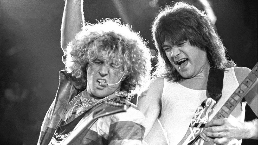 Guitarist Eddie Van Halen and Sammy Hagar are shown performing on stage during a 'live' concert appearance with Van Halen on 